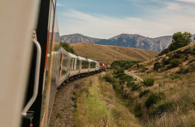 Treno in corsa sui binari tra le montagne